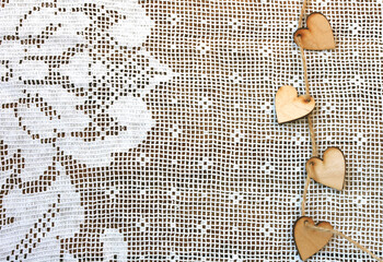 Wall Mural - valentine day background, wooden little heart with rope on white lace doily