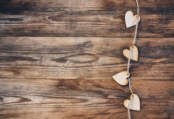 Wall Mural - valentine day background, wooden little heart with rope on wooden table