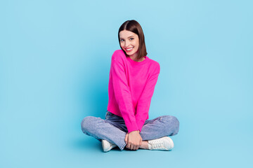 Wall Mural - Portrait of attractive shy cheerful girl sitting posing shopping day isolated over bright blue color background
