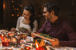 © Syda Productions - holidays, party and celebration concept - happy friends having christmas dinner at home