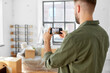 © Syda Productions - moving, people and real estate concept - man with smartphone taking picture of new home