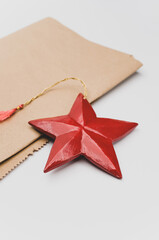 Poster - red wooden star Christmas decoration on a white and brown paper background