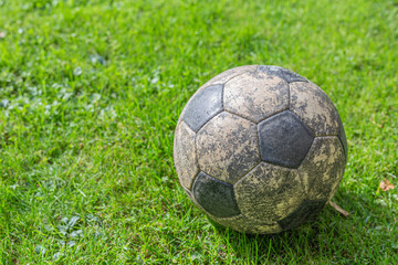 Wall Mural - Closeup shot of a dirty football ball outdoors