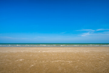 Wall Mural - sea sand and blue sky background