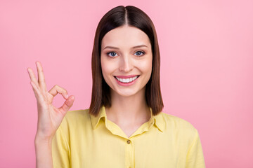 Wall Mural - Photo of young girl happy positive smile show okay alright symbol great perfect fine isolated over pink color background