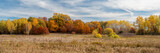 Fototapeta  - Fall colors over the prairie under blue cloudy skys