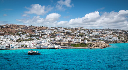 Fototapete - Panoramic landscape with town and windmills along coastline on Mykonos Island, Greece.