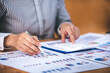 © Daenin - businessman or accountant who are using a calculator to calculate business data Accounting documents and laptop computer at the office business idea
