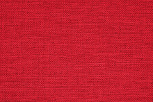 Close-up Of A Red Woven Surface. The Texture Is Similar To Linen. Fabric Background For Christmas Or New Year. Vivid Textured Woven Backdrop