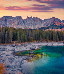 Wall Mural - Frozen Karersee lake, Province of Bolzano - South Tyrol. Mystical autumn sunrise in Dolomite Alps. Majestic outdoor scene of Itale, Europe. Beauty of nature concept background..