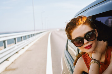 Wall Mural - pretty woman in sunglasses rides in a travel car