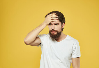 Canvas Print - emotional man in a white t-shirt irritated facial expression close-up