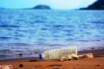 Environmental pollution: plastic bottle on the beach.	
