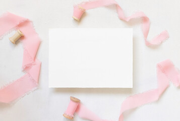 Wall Mural - Blank Card on table with pink flowers and ribbons