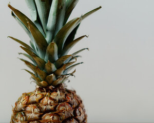 Poster - Close-up shot of a fresh organic ripe delicious pineapple isolated on a gray background