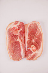 Wall Mural - Close up of sliced raw pork shoulder with skin on dark surface.