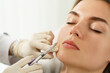 © blackday - Woman during facial filler injections in aesthetic medical clinic