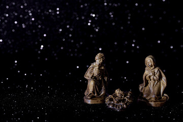 Christmas crib on stars background with space for text.