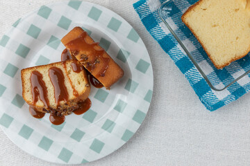 top view of two slices of walnut bread with cajeta on a plate on a table