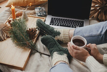 Woman With Cup Of Tea On Bed With Laptop, Christmas Lights, Stars, Pine. Cozy Winter Holidays