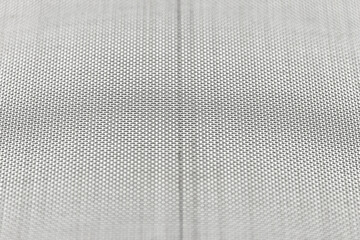 Background made from a macro photo of a fine metal mesh used for water filtration, isolated on a white background, selective focus.