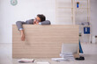 © Elnur - Young male employee working overtime in the office