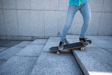 Wall Mural - Skateboarder riding  skateboard goring down the stairs outdoors in city