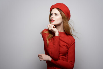 Canvas Print - pretty woman in a red sweater cosmetics emotion studio posing