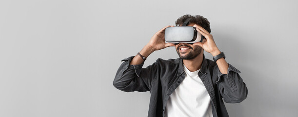 Young man using virtual reality headset panoramic banner. VR, future, gadgets, technology concept