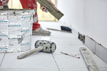 Wall Mural - Ceramics tile man worker placing new tiles on the floor and wall.