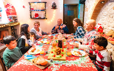 Wall Mural - Large multi generation family having fun at holidays dinner event - Winter x mas concept about grand parents eating together with children at home supper feast - Focus on grandfather in the middle