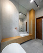 © Aleks Kend - Interior of bathroom in luxury flat. Grey and wooden design. White sink.