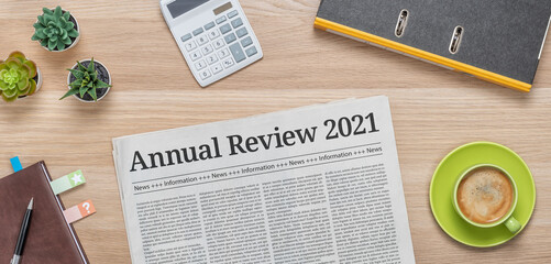 A newspaper on a desk with the headline Annual review 2021