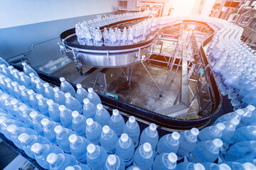 Wall Mural - Conveyor belt with bottles of drinking water at a modern beverage plant.