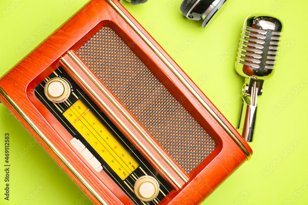 Retro radio receiver with microphone on color background