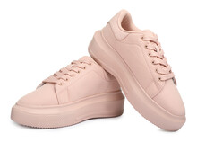 Pair of comfortable pink shoes on white background