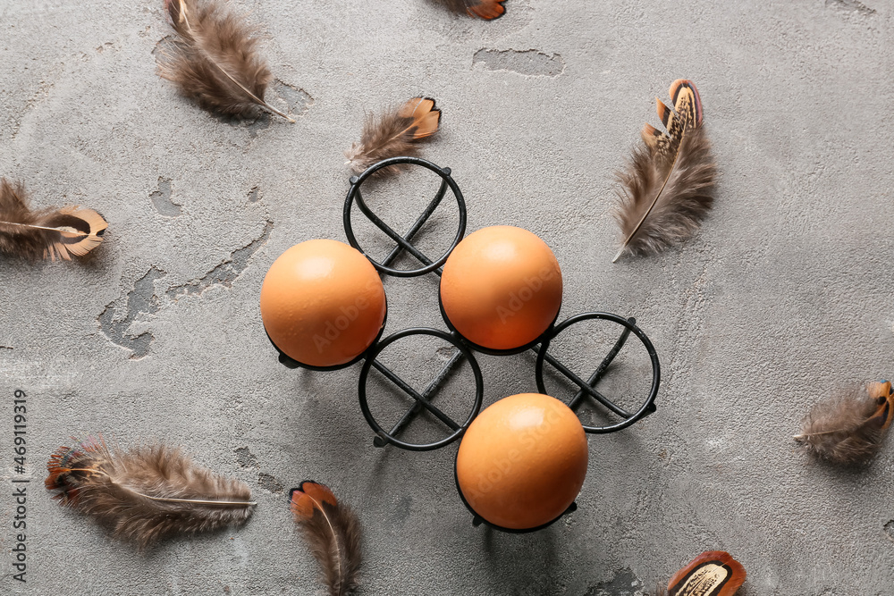 Beautiful pheasant feathers and eggs on grey background