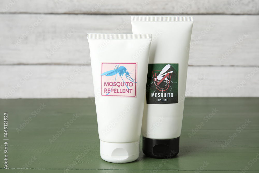 Mosquito repellent cream on color wooden background