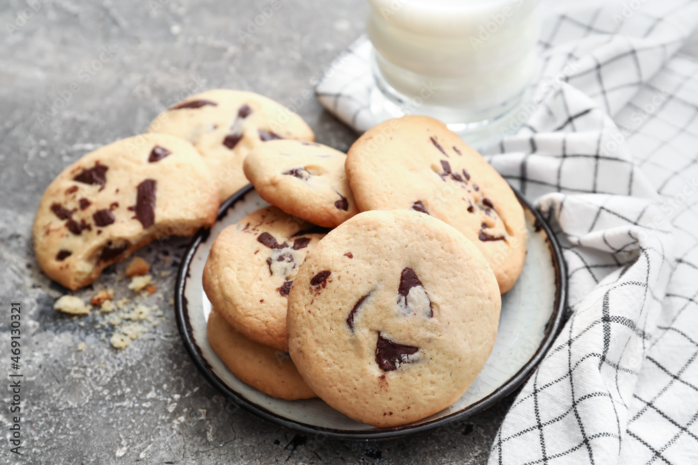 Delicious homemade cookies with chocolate chips on grey background, closeup