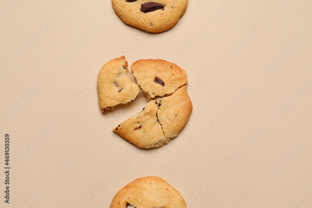 Delicious homemade cookies with chocolate chips on beige background
