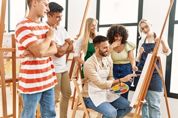 Poster - Group of people smiling happy and looking draw of partner at art studio.