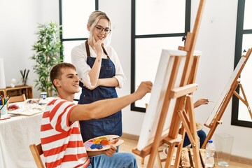 Poster - Art woman teacher smiling happy looking draw of paint student at studio.