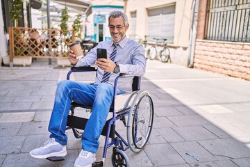 Sticker - Middle age hispanic man sitting on wheelchair using smartphone at street