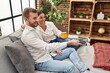 © Krakenimages.com - Man and woman couple drinking coffee watching tv at home