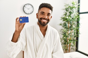 Sticker - Young african american holding credit card at beauty center.