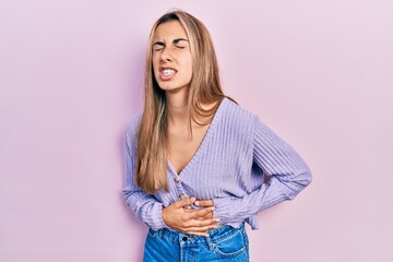 Poster - Beautiful hispanic woman wearing casual shirt with hand on stomach because nausea, painful disease feeling unwell. ache concept.