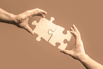 Wall Mural - Hand connecting jigsaw puzzle. Business solutions, success and strategy concept. Man hands connecting couple puzzle piece. Business solutions, target, success, goals and strategy concepts