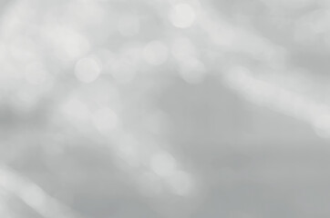 Wall Mural - blurred white bokeh on a gray background