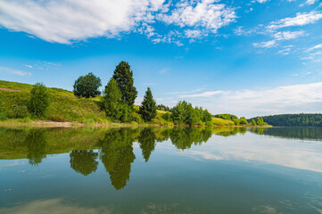 Wall Mural - Calm River. Clouds Reflection On Lake