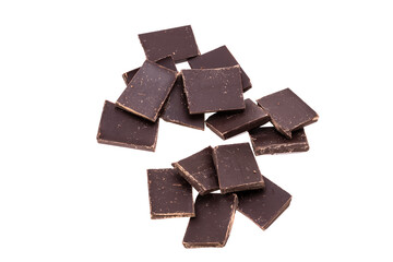 Poster - pieces of dark chocolate in a heap isolated on white background